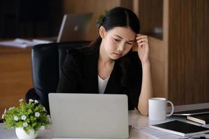 Company employees show boredom from unfinished work using computer notebook, documents and tablets at work. photo