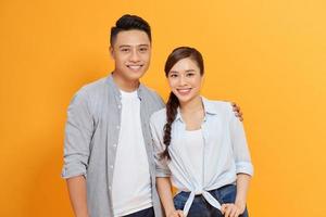 Couple life partners perfect match isolated over yellow color background photo