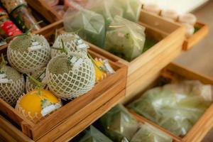 Netted Melon and Yellow Melon are wrapped in a foam net to reduce bruising and vegetable Sold in brown wooden crates in the supermarket. photo