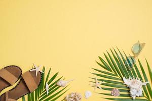 Leather sandals, tropical palm leaves, seashells, starfish on white background. Summer backdrop. photo