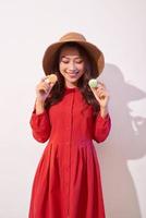 Sweet woman. Happy girl plays with macaroons. photo