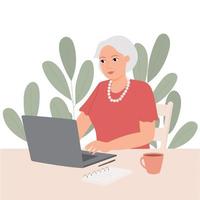 Happy granny with laptop on background of green plants. Business elderly woman is working, communicating, watching video vector