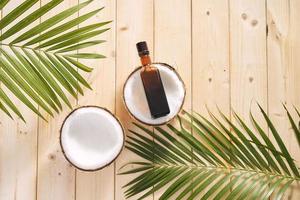 coconuts and coconut oil on wooden background. photo