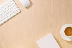 Flat lay, top view office table desk. Workspace with blank note book, keyboard, office supplies and coffee cup on wooden background. photo