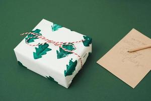 Envelopment and present box on blue background. Xmas concept, Noel concept. photo