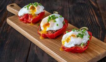 Stuffed peppers with meat with poached eggs photo