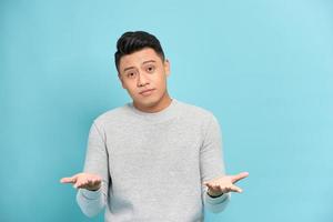 Young handsome man against a white background celebrating a victory or success, he is surprised and shocked. photo