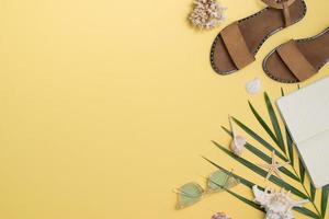 Leather sandals, tropical palm leaves, seashells, starfish on white background. Summer backdrop. photo