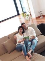 couple at modern home using tablet computer photo