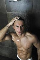 good looking man under man shower photo