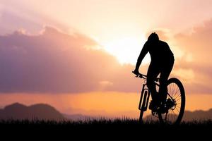 Silhouettes of bikes and cyclists travel concept and exercise by bicycle photo
