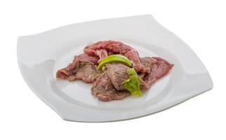 Beef carpaccio on the plate and white background photo