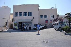 Santorini Greece, 2022 - Greek woman on the streets of Oia, Santorini, Greece photo