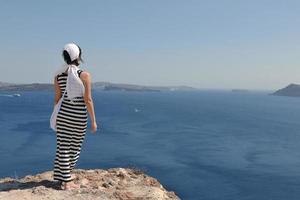 Greek woman on the streets of Oia, Santorini, Greece photo