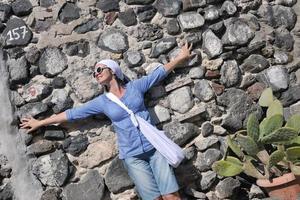 Greek woman on the streets of Oia, Santorini, Greece photo