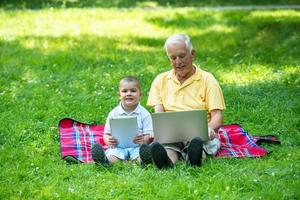 grandfather and child using laptop photo