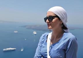 Greek woman on the streets of Oia, Santorini, Greece photo