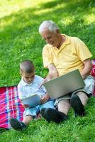 grandfather and child using laptop photo