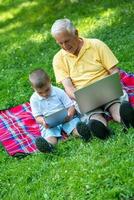 grandfather and child using laptop photo