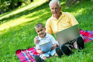 grandfather and child using laptop photo