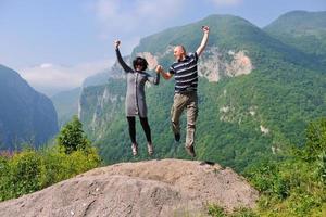 happy young couple jumping in the air photo