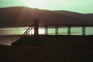 Dam with a tower and a bridge. photo