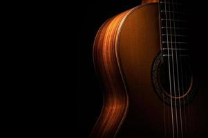 Classical guitar on a black background with copy space photo