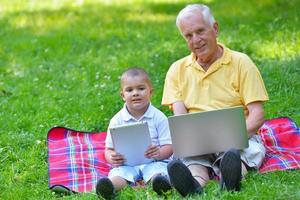grandfather and child using laptop photo