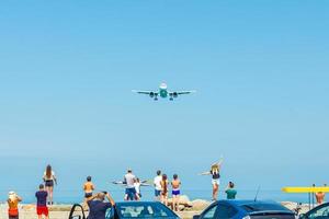 Batumi, Georgia, August 2, 2022, tourists and landing plane photo