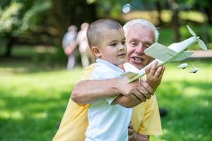 grandfather and child have fun  in park photo