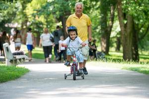 grandfather and child have fun  in park photo