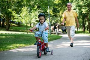 grandfather and child have fun  in park photo