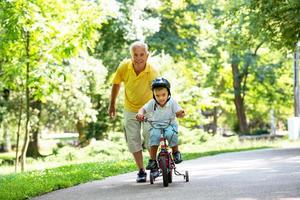 grandfather and child have fun  in park photo