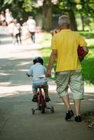 grandfather and child have fun  in park photo