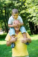 grandfather and child have fun  in park photo