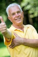 Portrait of smiling elderly man photo