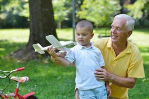 happy grandfather and child in park photo