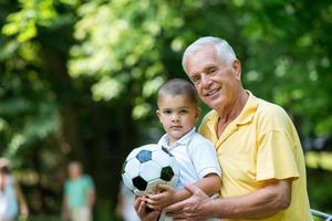 grandfather and child have fun  in park photo