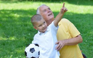 happy grandfather and child in park photo