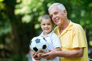 grandfather and child have fun  in park photo