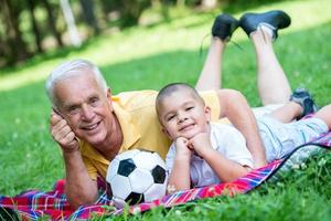 grandfather and child have fun  in park photo