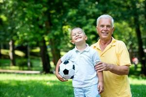 grandfather and child have fun  in park photo