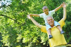 happy grandfather and child in park photo