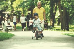 grandfather and child have fun  in park photo