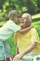 happy grandfather and child in park photo