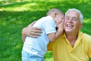 happy grandfather and child in park photo