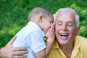 grandfather and child have fun  in park photo