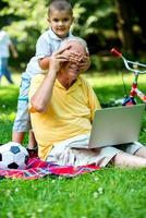 grandfather and child using laptop photo