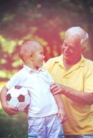 grandfather and child have fun  in park photo