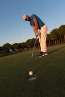 golfer  hitting shot at golf course photo